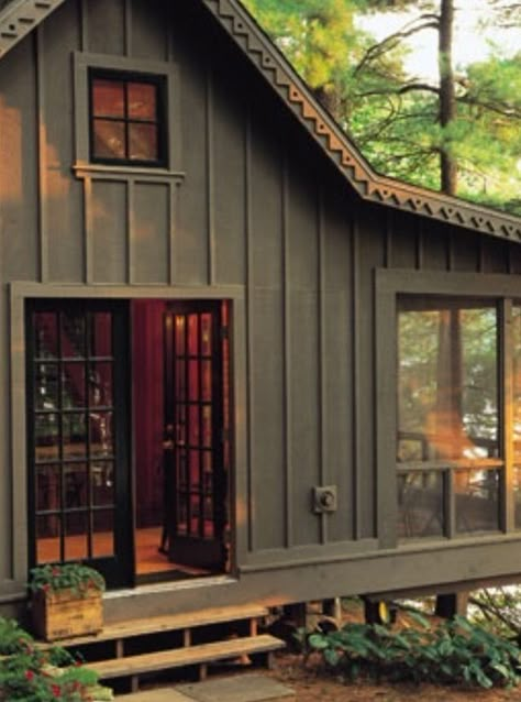 Dark Green Cabins, Dark Green Mountain Home Exterior, Verticle Siding Exterior Ranch, Dark Exterior Cabin, Painted Cabin Exterior, Dark Brown Cabin Exterior, Cabin Paint Exterior, Dark Green And Cedar House Exterior, Brown Cabin Exterior