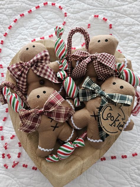 Aren't these gingerbread cookies totally scrumptious?  Add a little Christmas spirit in your home by placing them in a plate, bowl, tiered tray, on a shelf, in your Christmas tree or even in your Christmas wreath. They will also look nice hanging on a gift bag or on top of a gift.  Each gingerbread is hand sewn and measures approximately 5 inches tall. They are made of a high quality fabric and are stuffed with polyfiber stuffing. You may choose to add a ribbon loop for hanging in your Christmas Fabric Food, Christmas Bowl Fillers Ideas, Christmas Bowl Fillers, Gingerbread Fabric Ideas, Gingerbread Decor, Snowman Bowl Fillers, Bowl Fillers Wreaths & Garlands, Primitive Gingerbread Men No Sew, Gingerbread Man Fabric Ornament