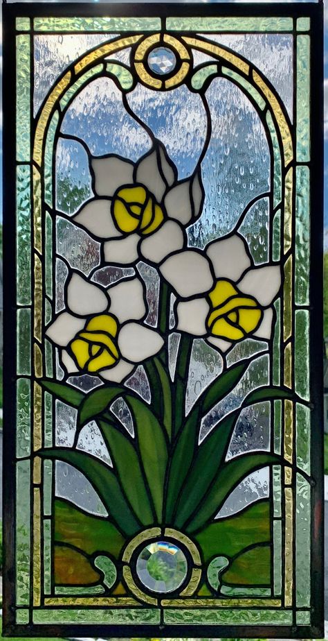 Daffodils Stained Glass PanelDimensions: approx. 11.5 inches x 23 inchesThe stained glass panel of Daffodils on a raining spring day is a stunning creation done in the Tiffany style, measuring 12x23 inches. The panel depicts the delicate daffodils with their vibrant yellow centers standing tall ami Daffodil Stained Glass Window, Stained Glass Yellow, Stained Glass Flowers Patterns Simple, Floral Stained Glass Patterns, Tiffany Stained Glass Windows, Hanging Stained Glass, Glass Painting Patterns, Stained Glass Door, Stained Glass Window Panel