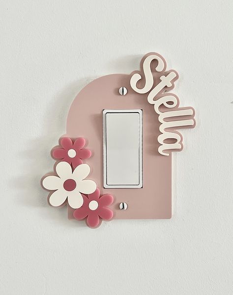 This personalized light switch plate cover is such a fun way to add a custom touch to any room. This cover is made from 1/8" acrylic. There is a stand off layer underneath so that your plate fits snug to the wall. See the video. You can choose: Single rocker Double rocker Triple rocker Single toggle Double toggle Triple toggle PLEASE SEE THE PHOTO SIZE:  Single plate cover measure approximately  5 1/2" tall x 5" wide (depending on the name) Double plate covers measure approximately 5 1/2" tall x Daisy Theme Bedroom, Aesthetic Light Switch Covers, Cute Light Switch Covers, Door Decorations Bedroom, Stalking Stuffers, Girls Room Accessories, Kids Lighting Bedroom, Girly Christmas Gifts, Pink Room Decor