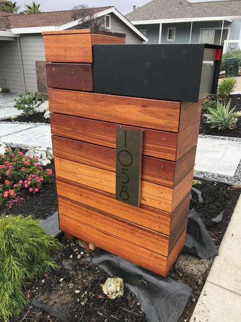 Batu wood structure with locking mailbox Locking Mailbox Ideas, Modern Mailbox Diy, Mailbox Modern, Wood Mailbox, Modern Mailbox Design, Mid Century Modern Mailbox, Mailbox Makeover, Wooden Mailbox, Mailbox Landscaping