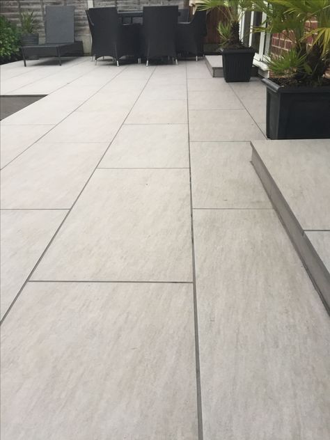 Outdoor porcelain tiles Modern Outdoor Tiles Design, Light Grey Porcelain Patio, Outside Floor Tiles Outdoor, Outdoor Porcelain Tile Patio Floor, Porcelain Patio Paving Ideas, Outdoor Tiled Patio, White Stone Patio, Porcelain Outdoor Tiles, Patio Tiles Ideas