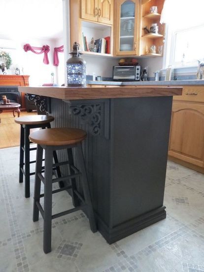 With the bottom half of a china cabinet, a piece of a solid wood door, and some decorative bookends, we have a beautiful kitchen island!  Come along with me to see how this transformation took place.   This is not the exact china cabinet we used but it is identical with one exception.  The one we used had a wheat sheaf etched into the face of the three bottom doors.   The countertop is made out of a piece of a solid wood door.  Solid wood doors are really solid core doors . . . they ar… Kitchen Island Makeover, Furniture Kitchen Island, Builder Grade Kitchen, Outdoor Kitchen Countertops, Wheat Sheaf, Rustic Kitchen Island, Kitchen Island Dining, Decorative Bookends, Real Kitchen