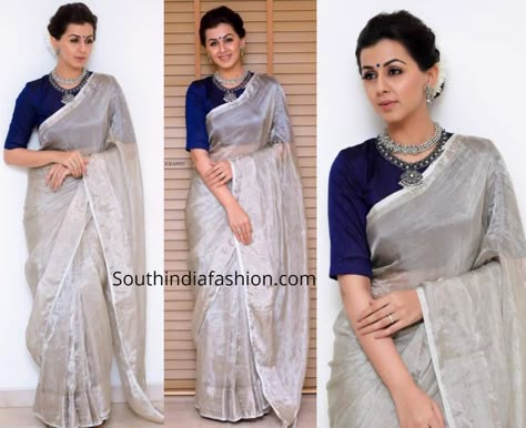 For a recent event, Nikki Galrani wore a plain silver tissue saree with contrast blue raw silk elbow length sleeves blouse by Anju Shankar. She styled her look with silver jewellery by Prade jewels, blue bindi and a gajra bun! Blouse For Silver Saree, Silver Tissue Saree Blouse Designs, Silver Saree Look, Silver Saree Blouse Design, Tissue Saree Blouse Designs, Silver Tissue Saree, Silver Saree, Kerala Saree Blouse, Kerala Saree Blouse Designs