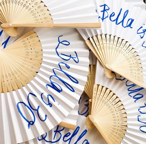 As a wedding florist and creative, I love adding creative touches to every couple's special day or event. And these beautiful paper fans are no exception! Handwritten with love and care, they're the perfect way to keep guests cool during those warm summer afternoons ☀️ You would have seen these everywhere this past summer, so we are expecting this trend to continue into next season... but not without creative twists! #WeddingFlorist #WeddingDecor #PaperFans #CustomFans #Handwritten #Summer... Paper Fan Wedding Decor, Paper Fan Arch, Paper Fan Photo Backdrop, Rattan Fans Wedding, Woven Fans Wedding, Paper Fans Wedding, Love And Care, Custom Fans, Paper Fans