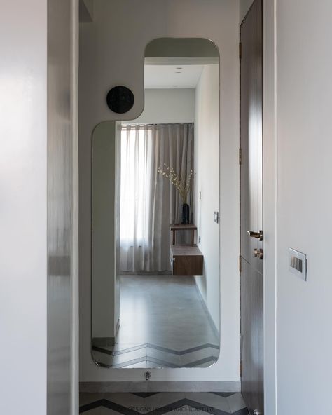 | Emerald retreat | Guest bedroom | Effortlessly blending functionality with style, this guest bedroom’s floor pattern draws you into a space where open and closed storage is accented by elegant glass shutters. The custom-shaped full-height mirror cleverly positioned behind the door amplifies the room, while the bespoke stone light adds a dash of whimsy. #codesigns #SmartDesign #GuestRoomChic #MirrorIllusion #bedroomdesign Photograohy by : @archi.capture_ [ Bedroom Design, Flute glass... Mirror Illusion, Glass Wardrobe, Full Mirror, Floor Pattern, Chic Spaces, Mirror Design, Mirror Shapes, Storage Mirror, Flute Glass