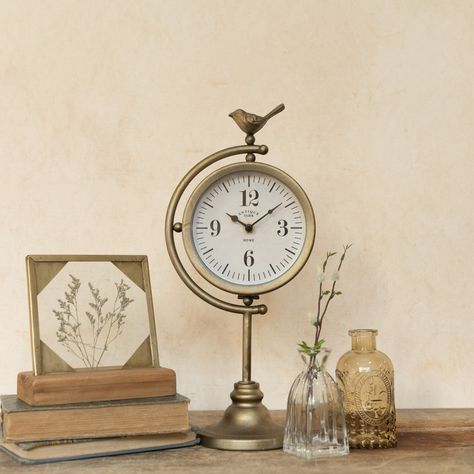 Add a touch of elegance to any room with our Antiqued Bronze Tabletop Clock featuring a beautiful perched bird on top. Crafted from durable metal and glass, this circular clock is both functional and decorative, making it the perfect addition to any home decor. Specifications Made of: Metal Dimensions: L: 7in W: 4.75in H: 15in Old World Home Decor, Wagon Planter, Old World Home, Furniture Fabrics, Antique Clock, Tabletop Clocks, Brass Lamp, Table Clock, Bath Linens