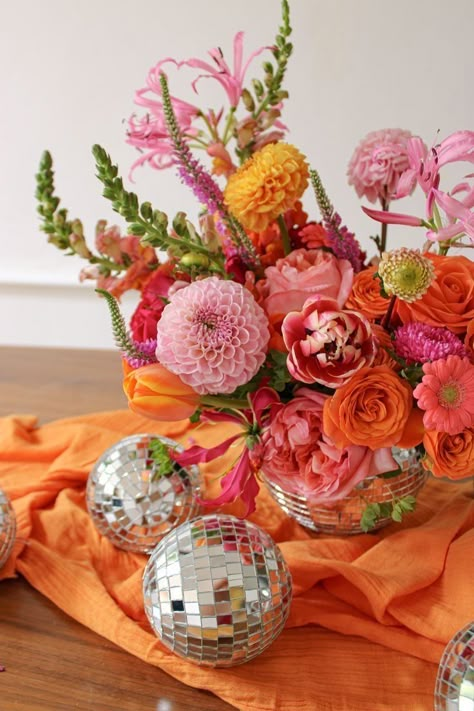 Disco Party Flowers, Floral Disco Party, Disco Theme Flower Arrangements, Orange Engagement Party, Pink And Orange Bridal Shower Decor, Pink And Orange Graduation Party, 70s Theme Floral Arrangement, Disco Balls And Florals, Summer Sunset Party