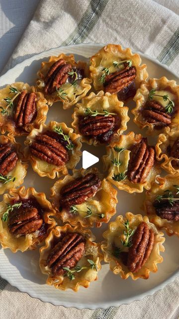 Brooke Carson on Instagram: "CRANBERRY BRIE BITES 🧀 The perfect little bite! This appetizer is only 4 ingredients, takes only 10 mins to come together with 15 mins in the oven - the ideal holiday app 🤩 INGREDIENTS: - 1 package phyllo dough cups (15 cups) - 7 oz canned cranberries - 1/4 wheel of Brie cheese, diced into bite sized pieces - 15 candied pecans - Fresh thyme DIRECTIONS: 1. Place your phyllo dough cups onto a baking sheet. Add 1 tsp cranberries, a piece of brie and a candied pecan to each cup 2. Bake at 350 for 15 minutes, top with fresh thyme to garnish & ENJOY! ✨ #brie #cranberrybriebites #holidayapp #holidayappetizer #easyholidayapp #thefeedfeed" Phyllo Dough Cups, Cranberry Brie Bites, Candied Pecan, Canned Cranberries, Cranberry Brie, Phyllo Cups, Healthy Thanksgiving Recipes, Frosting Recipes Easy, Brie Bites