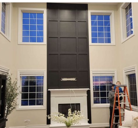 High Ceiling Fireplace Wall Modern, Tall Black Fireplace Wall High Ceilings, Tall Fireplace Accent Wall, Urban Bronze Fireplace Wall, Black Floor To Ceiling Fireplace, High Ceiling Living Room Tv Wall, Two Story Family Room With Fireplace, Black Accent Wall With Windows, Two Story Accent Wall