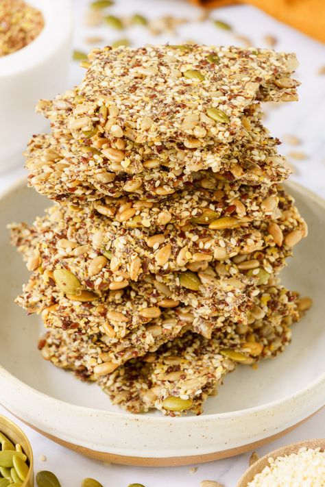 A stacked pile of seed crackers on a round plate. Vegan Recipes Italian, Homemade Seed Crackers, Christmas Food For Kids, Seeded Crackers, Flaxseed Crackers, Wellness Foods, Seed Crackers Recipe, Flax Seed Crackers, Chickpea Flour Recipes