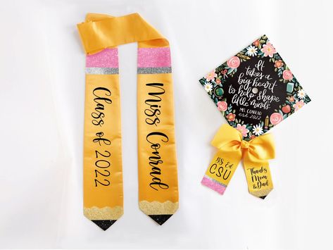 "With fast shipping and a personalized design, our coordinating stoles, bows, and cap toppers are the perfect way to personalize the big day! Select just one item, a combination of two, or all three! Combinations of 2+ items reflect a $5 off discount. Stole, Bow, and Topper are all personalized with your choice of text- include a quote, name, monogram, year, school, degree, or any short message! Bow and Stole are finished with glittering pencil accents and glittery black custom text. Topper is p Teacher Graduation Sash, Teacher Graduation Stole, Teacher Cap Decoration Graduation, Graduation Cap Decoration Teacher, Master's Graduation, Teacher Graduation Cap, College Inspiration, Teacher Graduation, Graduation Sash