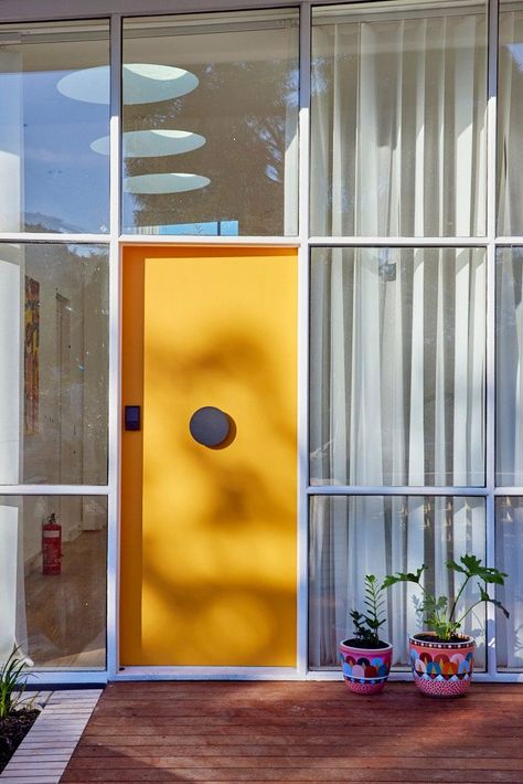 An orange front door on Tanya and Vito's Mid Century Modern renovation on The Block 2021 Front Door 70s House, 70s Front Door, 50s Front Door, Mid Century From Door, Mid Century Modern Front Door With Sidelights, Mcm Exterior Door, Mid Century Mod Front Door, Midcentury Front Door, Retro Front Door