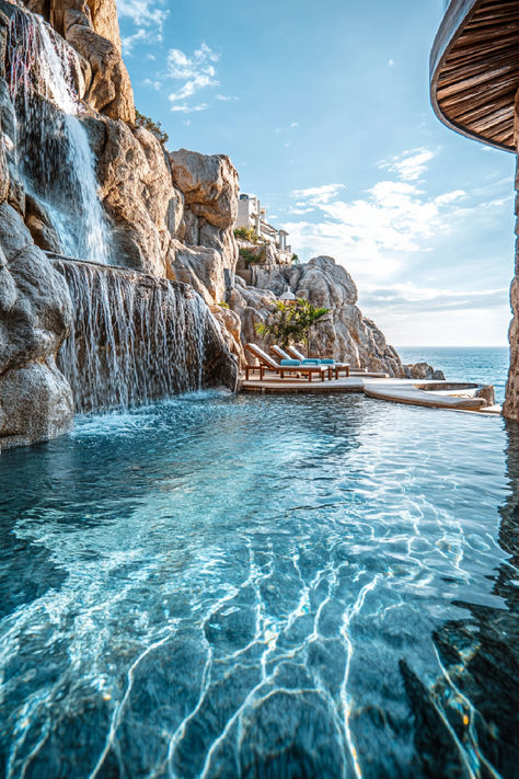 A stunning view of a luxurious spa resort in Cabo San Lucas, featuring a serene infinity pool with cascading waterfalls surrounded by rocky cliffs and overlooking the ocean under a bright blue sky. Cabo Mexico Resorts, Tulum Mexico All Inclusive Resorts, Miss Mexico, Hydrotherapy Spa, Cabo San Lucas Hotels, Spa Retreats, Cabo Resorts, Luxury Spa Resort, Secrets Resorts