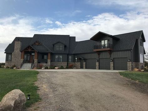 iron ore exterior modern farmhouse Dark House With Stone Exterior, Modern Farmhouse Exterior Brick And Siding, Iron Ore Farmhouse Exterior, Black Country House Exterior, Dark House Exterior Single Story, Black Barndominium Exterior With Stone, Dark Modern Farmhouse Exterior Colors, Black And Grey Barndominium, Black One Story House