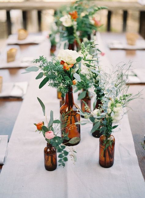 Empty Glass Bottles Fill In As Gorgeous Wedding Centerpieces Glass Bottles Wedding, Beer Themed Wedding, Long Table Wedding, Rustic Wedding Decorations, Deco Champetre, Bottle Centerpieces, Flowers And Greenery, Beer Theme, Budget Friendly Wedding