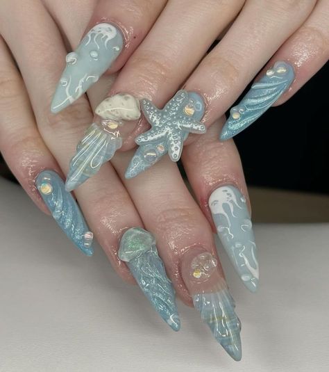 Dive into an ocean of elegance with our Ocean Fantasy Press On Nails Set! This stunning collection features hand-painted 3D designs inspired by the beauty of the sea, including starfish, shells, and ocean waves. Each nail is adorned with iridescent details that capture the shimmering magic of the underwater world, making these nails perfect for beach lovers and mermaid enthusiasts. 🐚💙  Set Includes: 10 hand-painted press on nails with unique 3D sea creature designs and iridescent accents.  Designs: 3D Starfish & Shell Charm: A captivating design featuring a 3D starfish and shell charm, set against a translucent blue base. The realistic textures and iridescent details make this design perfect for ocean lovers. 🐚⭐ Ocean Wave Patterns: Intricate wave designs flowing across a pale blue base Nails Nautical, Nails Mermaid, Fake Acrylic Nails, Sea Nails, Jellyfish Design, Mermaid Vibes, Mermaid Nails, Sea Inspired, Press Ons