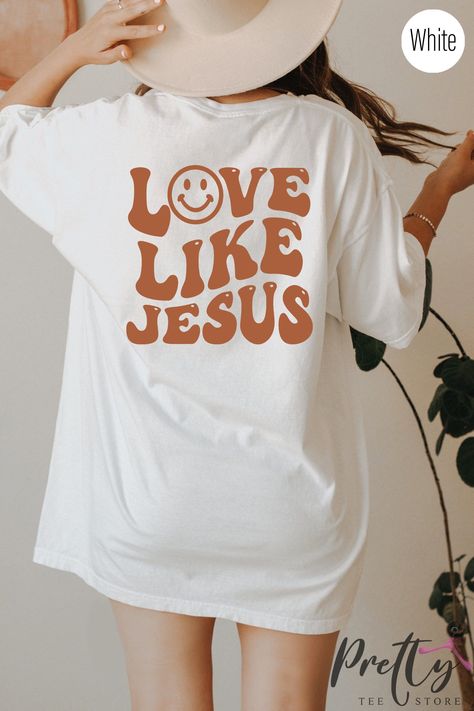 Enhance your style while showcasing your unwavering faith with our vibrant Jesus Shirt. This elegant and fashionable Christian apparel adds a pop of color to your wardrobe, instantly grabbing attention. Let your clothing become a powerful reflection of your beliefs and stand out from the crowd. Discover a unique way to express your devotion through fashion. #FaithFashion #ChristianApparel #FashionableFaith Christian Drip, Trendy Tshirt Designs, Christian Clothes, Faith Tshirts, Jesus Girl, Christian Shirts Designs, Christian Merch, Jesus Sweatshirts, Hoodie Ideas