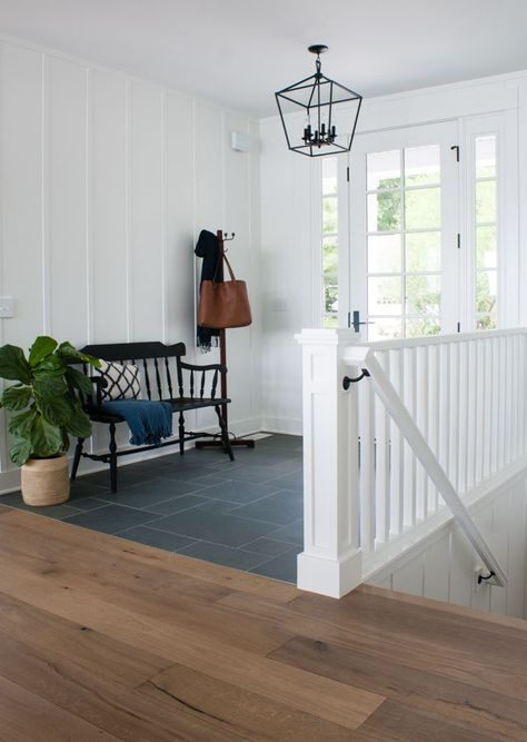 lake house with montauk blue slate tile in the entry, white board and batten walls and natural wood floors add to the cottage style Slate To Wood Floor Transition, Tile Entryway Transition To Wood Modern, Slate And Wood Floor, Spanish Tile Floor Entryway, Montauk Blue Slate Floor, Front Hall Tiles Entryway, Tile And Wood Floor Transition, Tile Entryway Transition To Wood, Foyer Flooring Ideas Entryway