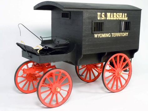 "Model Kit that requires assembly. Previous modeling experience recommended. BRIEF HISTORY The U.S. Marshal's Jail Wagon is an accurate replica ( 12 times smaller) than the real one still proudly displayed in Wyoming. Often referred to as a \"Tumbleweed Wagon\" it was used by the Marshals to round up Federal prisoners from local jails. KIT FEATURES * Laser Cut Sheets ... 7 Basswood and 1 Gasket Material (for wheel rims) * Basswood ... 4 lengths of 12\" fractional sized. * Brass and Iron for hub caps and bar rods. * Aluminum ... machined wheel hubs * White Metal Castings ... 60 parts * Brass nails * Instruction Manual and Parts List ... 33 pages. * Plans ... 5 Sheets MODEL SPECIFICATIONS * Length 12-3/4\" * Width 5-3/4\" * Height 9\" * Scale 1:12" Miniature Wagon, Metal Model Kits, Us Marshals, Making Wooden Toys, Metal Models, Miniature Toys, Old West, Metal Casting, Wheel Rims