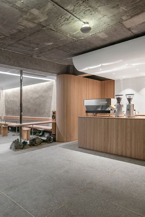 Sleek design is paired with traditional Korean elements at Cafe Oriente in Seoul’s creative Itaewon neighbourhood. Designed by local practice, Labotory, the cafe is partially submerged into the ground and features a combination of raw concrete, untreated wood, gravel, rock and a touch of greenery.

Photography: Yongjoon Choi

#southkorea #seoul #cafe #minimalistdesign #minimalism #design #travel #concrete #interior #interiors #interiorstyle Minimal Cafe, Cafeteria Design, Wood Cafe, Concrete Interiors, Cafe Shop Design, Modern Restaurant, Coffee Shop Design, Cafe Interior Design, Interior Modern