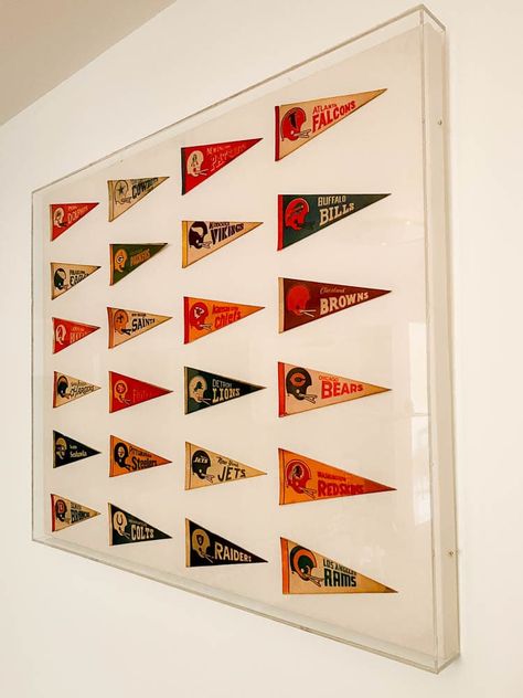 Sports Flags Decor, Framed Flag Decor, Sports Pennant Display, Gallery Wall Sports, Hanging Pennants On Wall, Pennant Display Ideas, Vintage Pennant Decor, Vintage Pennants Display, Pennet Flag Decor