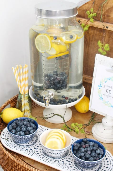 Flavored water beverage bar with lemons and blueberries. It looks cute and is a good reminder to drink your water everyday! / #beveragebar #flavoredwater #summerdecor #summerdecorating #diningroomdecor Blueberry Shower Theme, Summer Kitchen Ideas, Blueberry Party, Blueberry Drinks, Blueberry Water, Summer Decor Ideas, Drink Your Water, Shower Garden, Beverage Bar