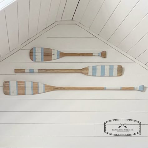 "Elevate your home decor with our beautifully handmade painted paddle wall art, a true testament to the timeless allure of coastal living. Inspired by the rustic beauty of the ocean, this hand-painted masterpiece brings a touch of seaside serenity right into your living space.  SIZES Small 35.25\" (89.5cm) length X up to 5.75\" (14.5cm) wide Medium 48\" (122cm) length X up to 5.75\" (14.5cm) wide Large 54\" (137cm) length X up to 5.75\" (14.5cm) wide STYLE  Choose from paint style  #1,#2 or #3 OUTDOOR/INDOOR These are made with the intention of being used for indoor wall decor, do don't expose to elements.  COLOR Natural unfinished wood with ivory and light coastal blue paint. Intentionally distressed/antique finish. HANGING OPTIONS Does not come with hardware as everyones wall situation a Beach House Color Palette, Coastal Blue Paint, Oar Decor, Painted Paddles, Beach House Colors, Lake House Interior, Lake Retreat, Beach House Wall Art, House Wall Art