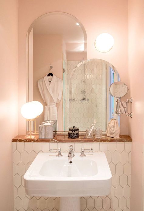 Cotton-candy-colored walls are matched with deep pink marble in a guest bath at Hotel des Grands Boulevards in Paris. (For more, see our feature on the interiors: Beds Take a Bow: The New Grands Boulevards Hotel in Paris.) Paris Hotel Interior, Coral Pink Bathroom, Modern Pink Bathroom, Vintage Tegel, Mini Bad, Hotel Interiors, Pink Bathroom, White Bathroom, Cheap Home Decor