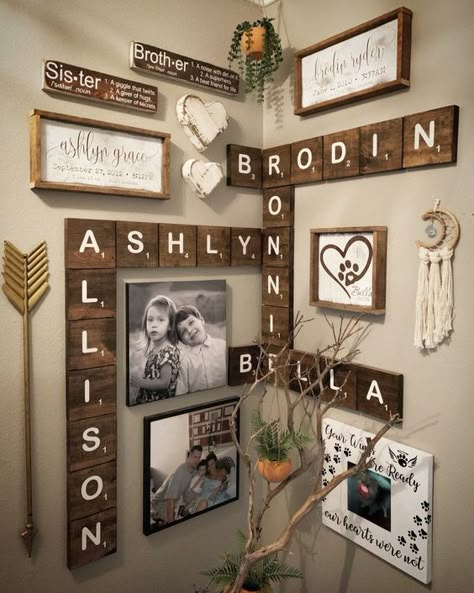 a rustic and boho gallery wall with wooden letters, signs in frames, some branches, arrows, tassels and potted greenery Scrabble Wall Decor, Rustic Gallery Wall, Scrabble Wall Art, Boho Gallery Wall, Scrabble Wall, Family Photo Wall, Family Wall Decor, Decorative Ideas, Scrabble Tiles