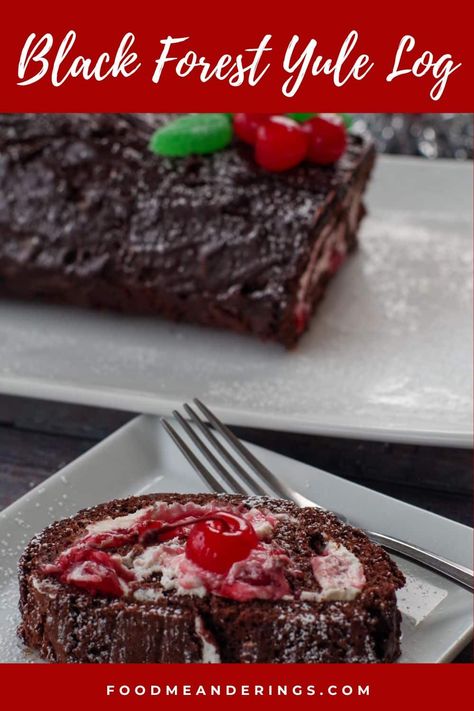 slice of black forest yule log cake on a white square plate with a fork and a whole black forest yule log cake in the background Black Forest Jelly Roll Cake, Chocolate Cherry Roll Cake, Black Forest Log Cake, Black Forest Swiss Roll Cake, Black Forest Yule Log Cake, Black Forest Swiss Roll, Black Forest Cake Roll, Black Forest Roll Cake, Easy Yule Log Cake Recipe