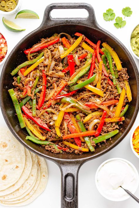 Try these sizzling ground beef fajitas – from stovetop to table in just 30 minutes! This easy ground beef recipe is a quick and satisfying one-pan dinner idea. The perfect weeknight meal but also fun for casual entertaining or Cinco de Mayo as well! Made with ground beef seasoned with a delicious homemade fajita seasoning, tender crisp fajita veggies served with tortillas and all your favorite toppings. Give this easy and delicious fajita recipe with ground beef a try! | www.mapleandmango.com Ground Beef Fajitas, Fajita Recipes, Geo Board, Turkey Recipes Healthy, Ground Beef Seasoning, Beef Roasts, Toddler Finger Foods, Week Night Dinners, Ground Turkey Recipes Healthy