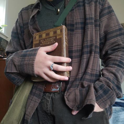 an outfit consisting of a brown checkered shirt over green sweater tucked into brown pants. the person is wearing this outfit and holding an old book. Mens Fall Outfits Dark Academia, Fall Mens Aesthetic, Cryptidcore Academia, Goblincore Men Outfits, Chaotic Academia Outfits Masc, Goblincore Dark Academia, Hobbitcore Fashion Men, Forest Academia Aesthetic, Cryptid Academia Outfits