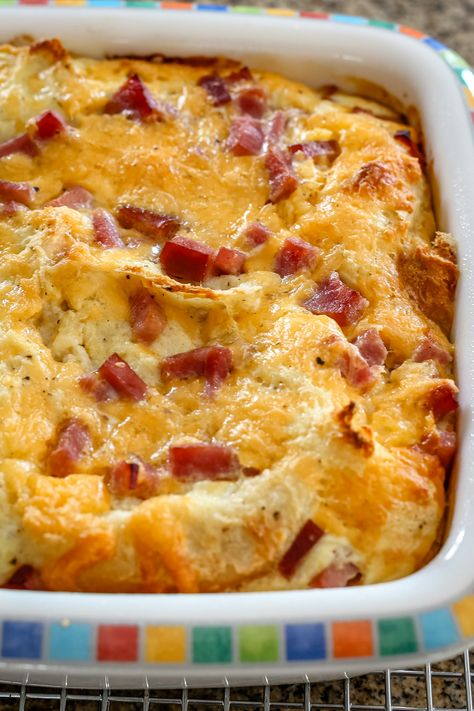 Make breakfast a breeze with this ham and egg breakfast casserole recipe. Just mix, bake, and serve a satisfying meal for the whole family. Egg Bakes Recipes, Egg And Ham Casserole, Egg Ham And Cheese Casserole, Ham And Egg Bake, Ham And Egg Breakfast Casserole, Ham Egg Bake, Breakfast Casserole With Ham, Ham And Cheese Breakfast Casserole, Overnight Egg Casserole