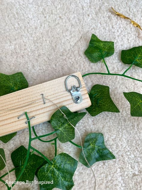 DIY Ivy Wall Decor (With Lights!) Decorating With Fake Ivy Vines, Diy Ivy Wall Backdrop, Decorating With Vines, Lighted Ivy Wall, Hanging Ivy Bedroom Ideas, Faux Ivy Wall Indoor, Fake Ivy Trellis Wall Diy, Ivy Fairy Light Wall Bedroom, Vine Party Decor