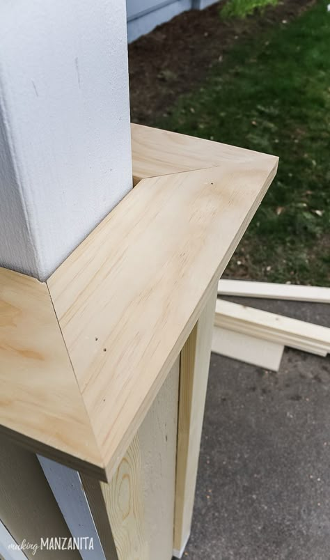 Use the miter saw to create 45 degree angles on the wood trim for the bottom porch of the DIY modern farmhouse porch post wraps. Learn how to build column wraps to add curb appeal to your front porch! #DIY #porch #posts #porchposts Porch Post Wraps, Front Porch Posts, Modern Farmhouse Porch, Porch Pillars, Front Porch Columns, Column Wraps, Front Porch Makeover, Add Curb Appeal, Column Covers