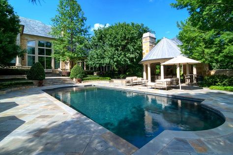 This spacious pool offers a popular feature called a tanning ledge or a sun deck area and creates a shallow area that can be used for kids, pets and to allow furniture to be placed in the water. Typically the ledge is just flat and does not have any slope on it. Outdoor Cabana, Pool Shapes, Rectangular Pool, Luxury Estate, Pool Photos, Luxury Pool, Traditional Landscape, Swimming Pool Designs, Patio Umbrellas