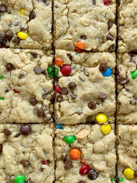 Soft-Baked Monster Cookie Bars - Together as Family Halloween Cookie Bars, Monster Cookie Bars Recipe, Leftover Halloween Candy Recipes, Mnm Cookies, Halloween Candy Recipes, Monster Cookie Dough, Monster Cookie Bars, Monster Cookies Recipe, Oats Chocolate