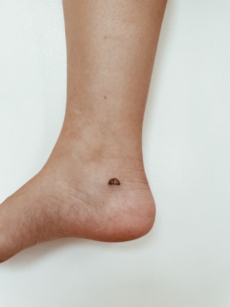 Small Parisian Tattoos, Tiny Croissant Tattoo, Croissant Tattoo Minimalist, Crossaint Tattoo, Parisian Tattoo, Europe Tattoo Ideas, Paris Tattoo Ideas, Question Mark Tattoo, Croissant Tattoo