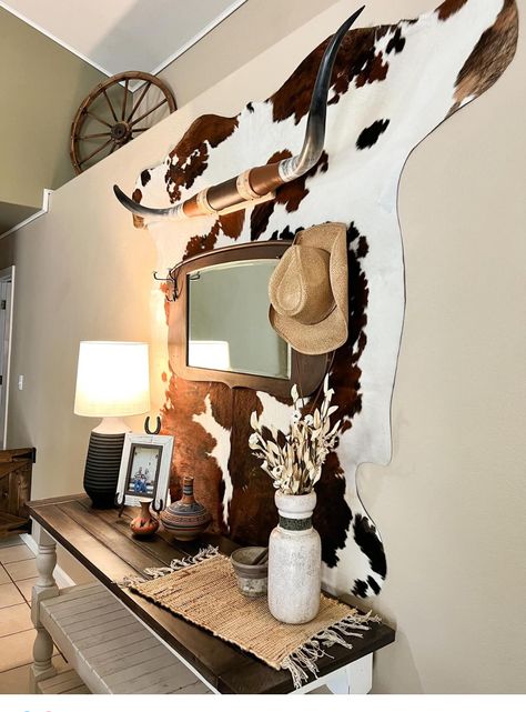 Cow Hide Decor Wall, Cowhide Rug On Wall With Pictures, Boho Western Salon Decor, Bear Skin Rug On Wall, Western Bar Cart Ideas, Light Western Aesthetic, Cowhide Furniture Diy, Cowhide Wall Decor Living Room, Cozy Western Home Decor