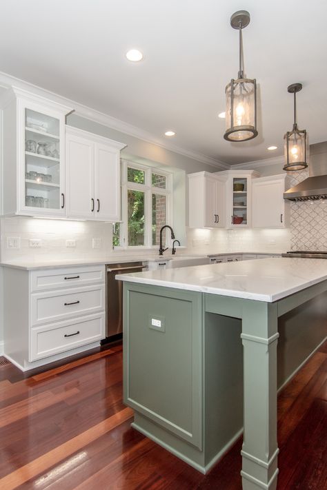 A sage green island paired with white cabinets creates a beautifully natural look that brings a refreshing and serene vibe to your kitchen.🌿 Colored Island With White Cabinets, White Cabinets With Colored Island, Green Island White Cabinets, Sage Green Island Kitchen, White Kitchen With Colored Island, White Kitchen With Green Island, Green Kitchen Island White Cabinets, Sage Green Kitchen Island, Sage Green Island