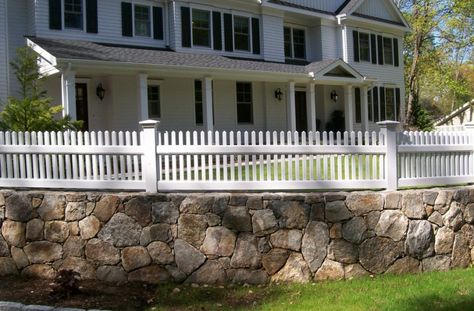 2 Foot Stained Picked Fence with Colonial Caps on Stone Wall in Westport, CT, installed by A. Anastasio Fence Company. Front Yard Stone Wall Fence, Picket Fence On Stone Wall, House With Picket Fence Front Yards, Fence With Stone Columns, Picked Fence, Retaining Wall Fence, Courtyard Wall, Backyard Wall, White Picket Fence Corner Lot