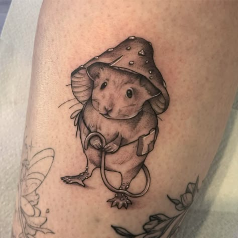 Tattoo mouse in a mushroom hat holding his tail with a bag around his waist and black and grey Woodland Mouse Tattoo, Mouse Mushroom Tattoo, Mouse And Mushroom Tattoo, Rat Mushroom Tattoo, Mushroom Shoulder Tattoo, Goth Mushroom Tattoo, Mouse Tattoo Cute, Cute Mouse Tattoo, Cottagecore Tattoo Ideas