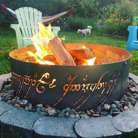 This fire ring is straight out of the mystical world of LOTR. Made of steel, this ring is perfect for that backyard dinner in the winters. Place it as a decor piece in your home to flaunt your eternal LOTR Fandom! It’s going to make a lot of fans jealous! Lotr Fire Pit, Lord Of The Rings Fire Pit, Covered Fire Pit, Permanent Campsite, Backyard Circus, Diy Fire Pit Ideas, Burn Barrel, Cordwood Homes, Fire Pit Ring