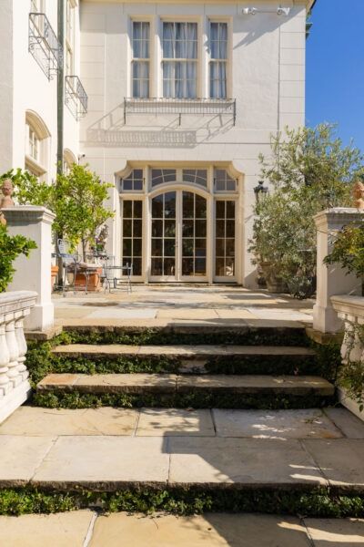 Chateau charm: a glimpse into grandeur on Audubon Boulvard Small French Chateau, Basketweave Tile Floor, Small Mansion, Basket Weave Tile, French Exterior, Hip Roof, Fantasy Homes, French Chateau, House Hunting