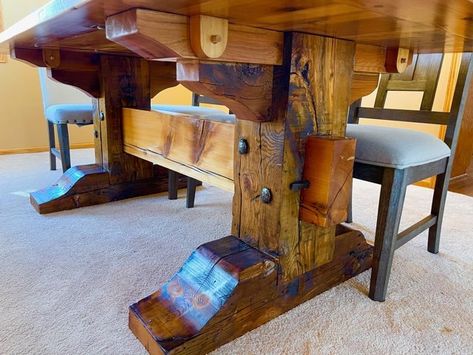 This dining table is built of salvaged wood from a downtown Minneapolis warehouse. The top is made of standard pine boards while the base is a trestle style made of 14 inch support beams anchored with the original metal ties. Live Edge Table Legs Ideas Wood, Dwarven House, Live Edge Table Legs, Granite Projects, Beam Table, Wood Dining Table Rustic, Unique Dining Tables, Wood Table Diy, Downtown Minneapolis