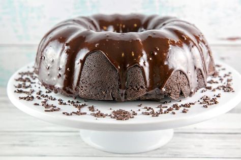 a dark chocolate bundt cake covered in chocolate ganache on a white cake plate Chocolate Rum Cake, Dark Chocolate Cake Recipes, Gluten Free Chocolate Cake, Beer Cake, Chocolate Bundt Cake, Dark Chocolate Cakes, Rum Cake, Dessert Cake Recipes, Fudge Cake