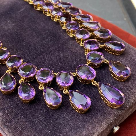 Details: Stunning Amethyst and 14K gold necklace. The necklace along has 34 amethyst ranging in size from 8mm x 9mm to 9.8mm x 17.6mm. The drop on the largest amethyst measures 34.6mm (about 1.4 inches). The appraisal value of this is $5,500. From Appraisal: One (1) fourteen karat yellow gold amethyst fringe necklace. Set in four prong open work gallery crowns are seventeen (17) faceted oval amethysts, graduating out from the center (12.85 x 9.74 x 5.54 mm), weighing approximately 53.77 carats c Purple Gemstone Necklace, Necklace Stone Jewellery, Antique Amethyst Jewelry, Amethyst Jewelry Necklace, Victorian Jewelry Necklace, Princess Jewelry, Magical Jewelry, Unusual Jewelry, Fringe Necklace