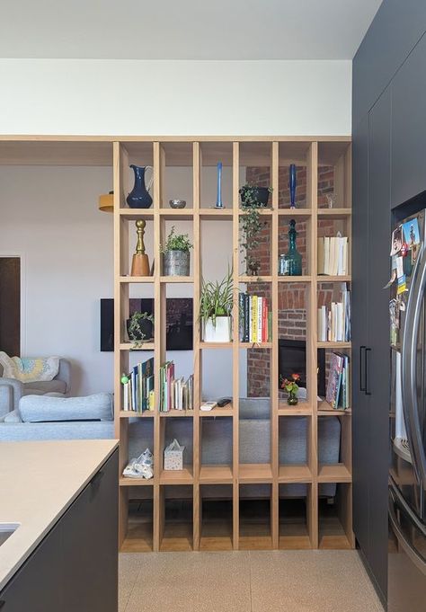 A custom timber dividing screen between the Kitchen and Living areas. The screen acts as a subtle divide and can display cookbooks, indoor plants and other special items. Shelves Dividing Rooms, Between Kitchen And Living Room, Kitchen And Living Room Divider Ideas, Kitchen Living Room Divider, Duplex Decor, Display Cookbooks, Dividing Screen, Living Room Divider Ideas, Timber Screen