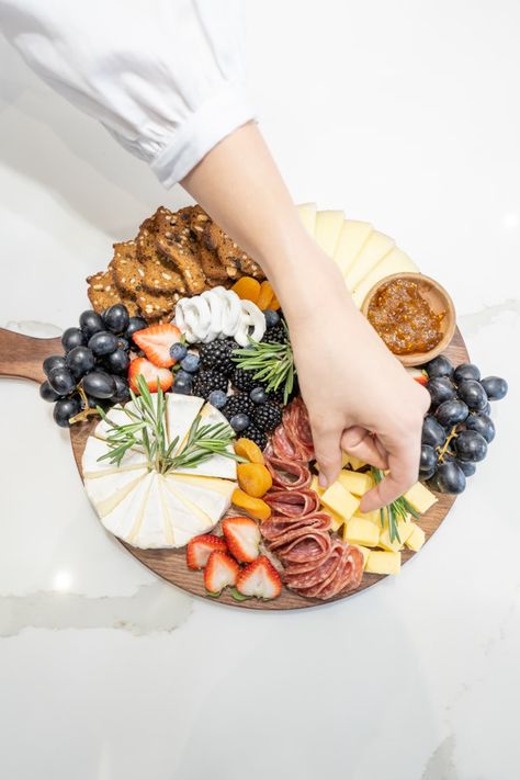 A person reaching for a platter of food photo – Free Food Image on Unsplash Charcuterie Board With Brie, Grazing Food, Cut Recipe, Grazing Board, Olive Recipes, Appetizer Platters, Cheese Board Set, Charcuterie Platter, Chutney Recipe